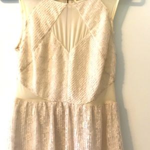 Creamy lace dress with sheer cutouts.
